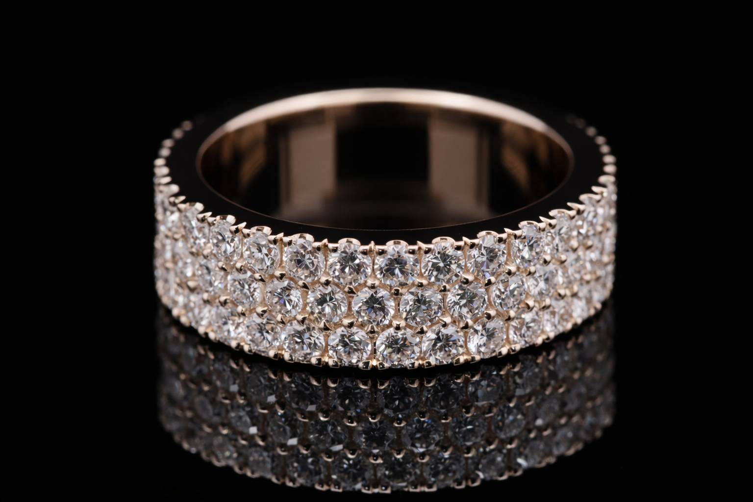 Rose gold ring with diamonds on a black background